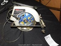 Side angle showing the entire saw, power cord, and blade guard.