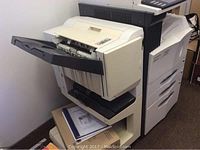 Full view of Kyocera KM-3035 multifunction copier with paper output tray open, showing condition and size.