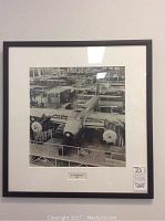 Full view of the framed black and white photo showing the DH98 Mosquito aircraft inside a factory setting.