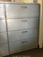Full view of the gray metal 4-drawer file cabinet showing front and drawer handles