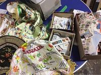 Photo of boxes with assorted stamps, some loose and some on cloth with Canada theme