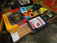 Top view of the collection including multiple die cast cars, the gas pump island boxed toy, and miniature picnic set.