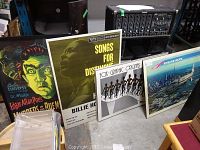 Four prints displayed side by side, showing detailed artwork and context