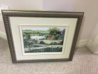 Framed painting depicting a rural country landscape with a river and houses in the distance, size approximately 8.5x11.5 inches.