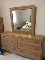 Front view of dresser with mirror mounted on top, shows overall style and proportion