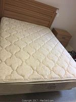 Full view of mattress on boxspring with headboard