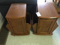 Pair of wooden end tables side by side, showing the tops and magazine racks on sides.