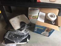 Overview of all items together including grill, blender in box, salad shooter, and slicer-shredder.