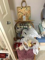 Group photo showing the knitting bag, straw hat, plastic bags with craft materials inside a basket and door knob.