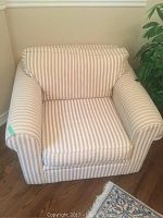 Front view of the Bauhaus style armchair with beige and white vertical striped upholstery, showing the full chair with padded arms and cushioned seat and backrest.