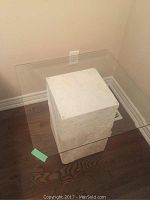 Top view of clear glass top with rounded corners placed on a white composite stone base.