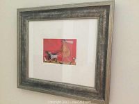 Framed print with glass cover from an angle highlighting the frame and artwork.