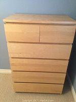 Front view of IKEA dresser showing six drawers with two smaller top drawers and four larger bottom drawers in light wood finish.