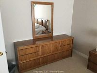 Full view of Thomasville wooden dresser with mirror attached, showing overall condition and style.