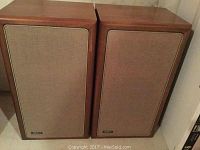 Pair of Advent speaker cabinets side by side, showing overall condition and wood veneer finish