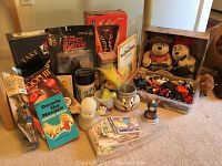 Photo of varied vintage collectibles including Dennis the Menace book, Casper figure, Puppet Master doll, chess set, teddy bears, mugs, and assorted small toys and cards.