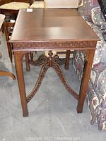 Full view of the Ethan Allen wooden end table showing the top surface and carved apron detail.