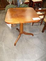 Side angle showing the pedestal base and the underside of the tabletop