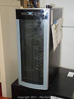 Front view of Avanti wine chiller with glass door showing control panel on top.