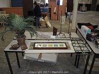 Full lot including potted faux palm plant, framed multi-picture wall art and other framed pieces, untested lamp, and metal candle sconce