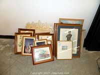 Grouped view of all framed artworks and prints, showing variety of sizes and subjects in wooden and light-colored frames