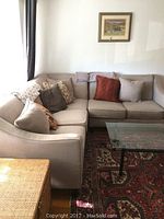 Full view of L-shaped taupe sectional with accent pillows