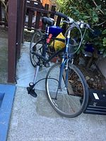 Full view of blue Giant Express hybrid bike with CCM pump and red folding lock attached to frame