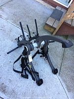 Full view of Saris bike rack showing overall shape, hooks, padded arms, and fastening straps.