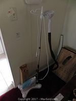 White and blue Tobi free standing clothes steamer shown assembled with adjustable pole and hose.