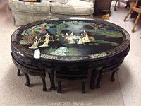 Overall view of oval coffee table with glass top and six matching stools