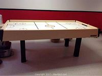 Full side view of air hockey table showing dimensions and leg design