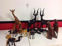 Wide view showing the entire collection of East African animal wood carvings in ebony and mahogany.