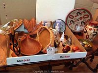 Overview of lot showing wooden bowls, pottery vase, clock, decorative eggs, and figurines