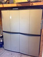 Two closed beige plastic Workforce cabinets side by side against wall