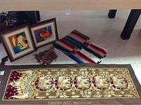 Thailand Elephant wall hanging displayed with framed marionette paintings and Mexican blankets in view.