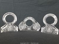 Front view of the three pinwheel crystal decorative frames, showing their varying shapes and circular photo openings.
