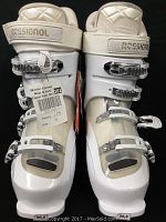 Front view of both white women's Rosignol ski boots showing adjustable buckles, straps, and size label 26.5.