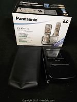 Panasonic cordless phone box with phone and accessories displayed.