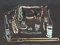 Overview of various necklaces, bracelets, and earrings arranged on a black background