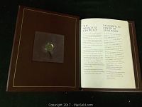 Photo showing the limited edition Center Ice Loon coin mounted in a booklet with bilingual text about the coin and its significance.