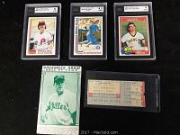 Top view showing three graded baseball cards: Steve Carlton, Pete Rose, Paul Molitor, plus Baseball's Great Hall of Fame card and Yankees ticket stub.