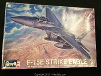 Front of the Revell F-15E Strike Eagle model plane kit box showing artwork of the jet in flight and branding.