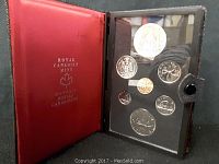 Red Royal Canadian Mint leatherette coin case open showing 8 Canadian 1976 commemorative coins in protective display slots with clear covers.