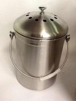 Front view of the stainless steel compost bin showing the cylindrical body, bail handle with plastic grip, and ventilated lid with knob.