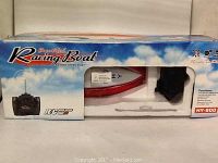 Boxed RC HY-800 racing boat with remote control visible through package window.