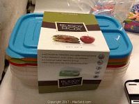 Four stacked Sunsella Buddy Box plastic food storage containers with lids in blue, orange, green, and red colors, packaged with brand sleeve around the set.