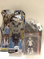 Photo of Batman Cyber Glider toy in original blister packaging alongside a Star Wars Biker Scout action figure in a clear plastic bag, showing lot contents.