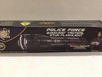 The product in its original packaging box showing the Police Force branding and 8,000,000 volts technical details.