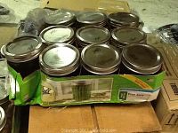 Pack of nine Ball wide mouth pint mason jars with lids in original box, showing jar tops and box label.