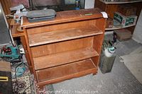 Three-shelf wood shelving unit with scratches, rectangular and compact